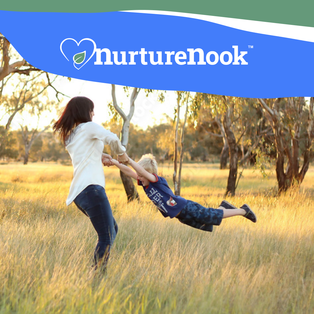 NurtureNook. Photo of a woman swinging her young son around in a wooded area